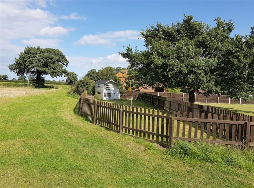 Fenced play area for children at Summer House Stables in Catfield, near Stalham, Norfolk
