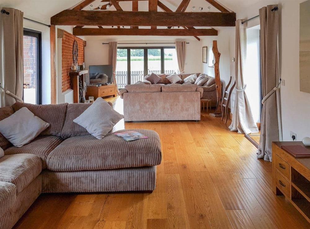 Spacious and luxurious beamed living room with wooden floor at Summer House Stables in Catfield, near Stalham, Norfolk