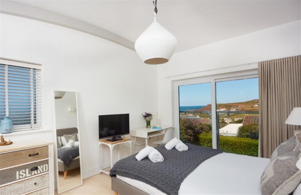 Sundown, Cornwall: Bedroom one with a king-size bed and Juliet balcony at Sundown, Bude