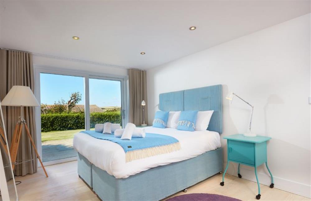 Sundown, Cornwall: Bedroom two on the ground floor with a king-size bed and en-suite shower room at Sundown, Bude