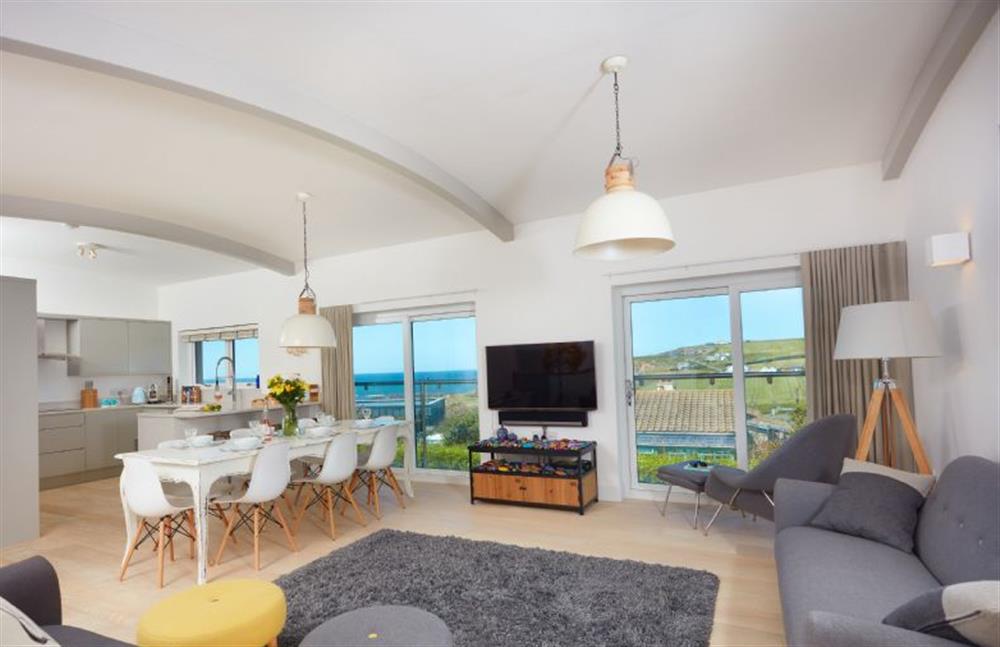 Sundown, Cornwall: Sitting room with comfortable seating, Smart television and Juliet balcony with stunning views over Widemouth Bay