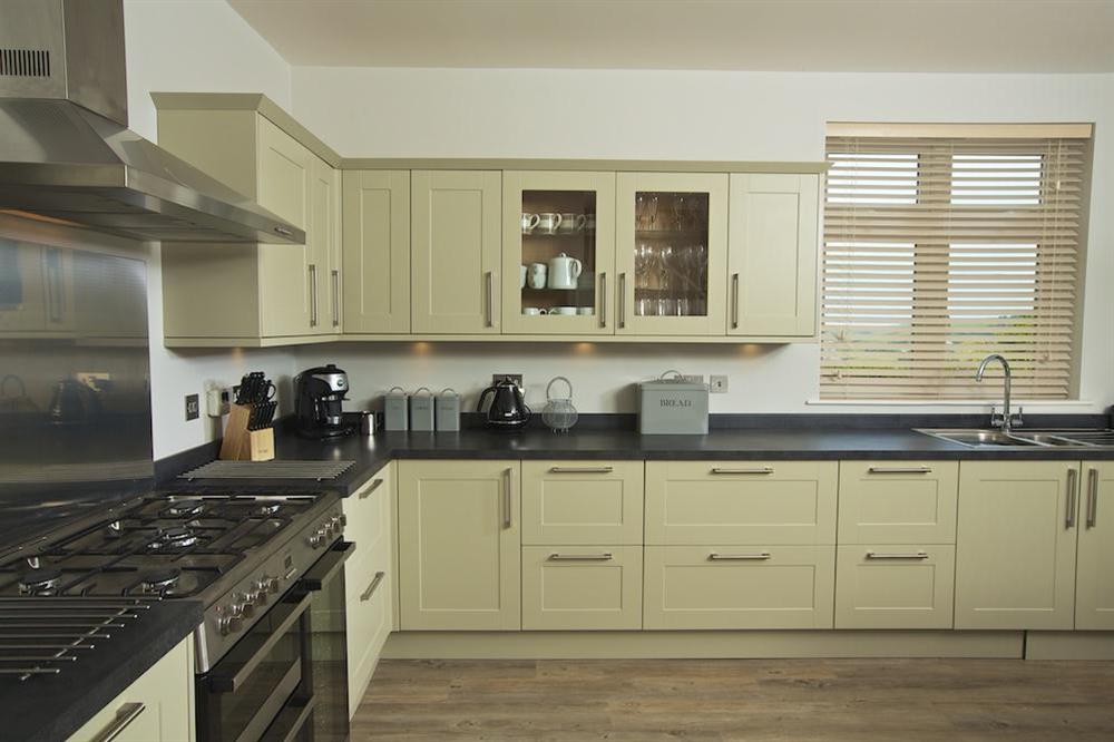 A stunning open-plan kitchen with contemporary Shaker-style kitchen units at Sundowners in , Salcombe