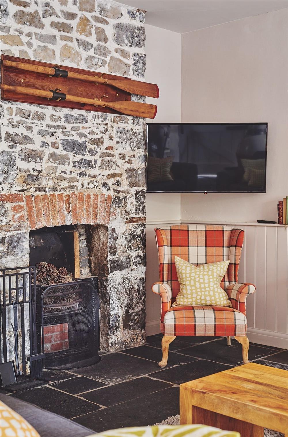 The single armchair beside the fireplace and Smart TV