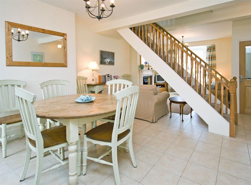Open plan dining and sitting room with staircase to first floor at Sunnidale in Salcombe, Devon