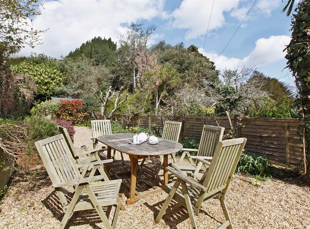 Sheltered sunny garden with raised flower beds, outdoor furniture and BBQ at Sunnidale in Salcombe, Devon