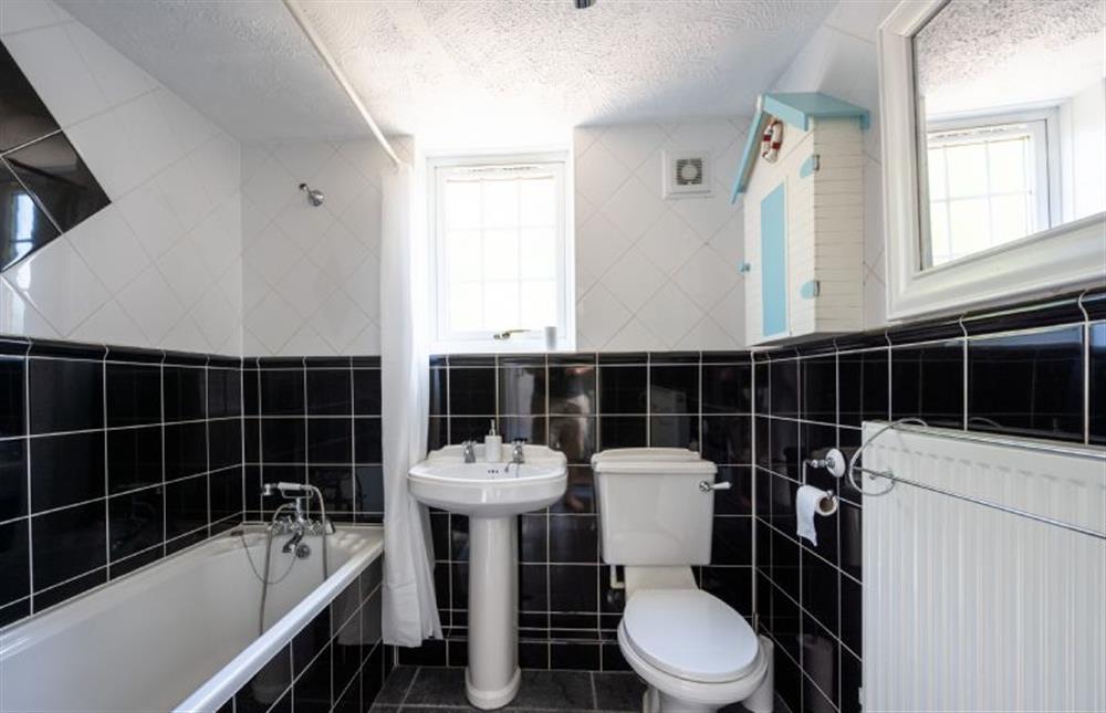 Ground floor: Bathroom with a bath and shower over, wash basin and WC at Sunny Beck Cottage, Mundesley near Norwich