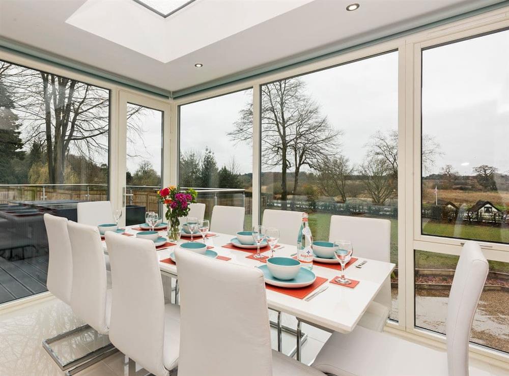 Delightful dining area with magnificent floor-to-ceiling windows at Sunnybank in Coltishall, near Wroxham, Norfolk, England