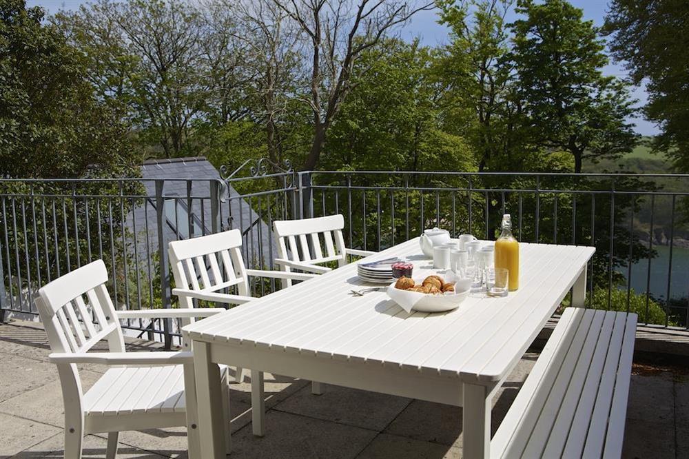 Enjoy breakfast on the terrace with views through the trees towards the estuary at Sunnylodge in , Salcombe