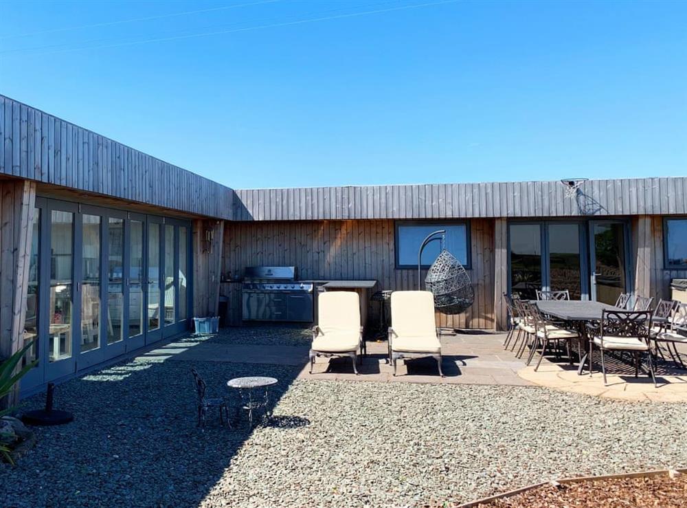 Enclosed courtyard with patio, garden furniture and gas BBQ (photo 2) at Sunnymeade in Stainton with Adgarley, near Dalton-in-Funess, Cumbria