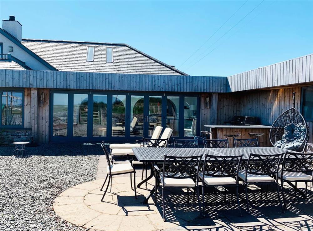 Enclosed courtyard with patio, garden furniture and gas BBQ at Sunnymeade in Stainton with Adgarley, near Dalton-in-Funess, Cumbria