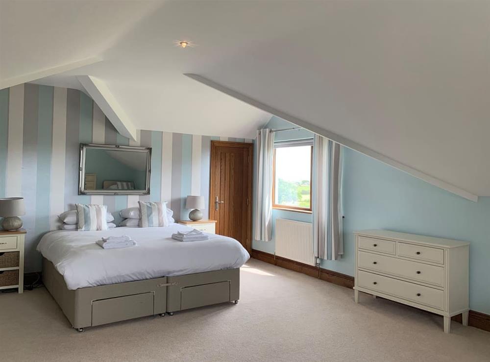Spacious bedroom with kingsize bed and twin beds at Sunnymeade in Stainton with Adgarley, near Dalton-in-Funess, Cumbria