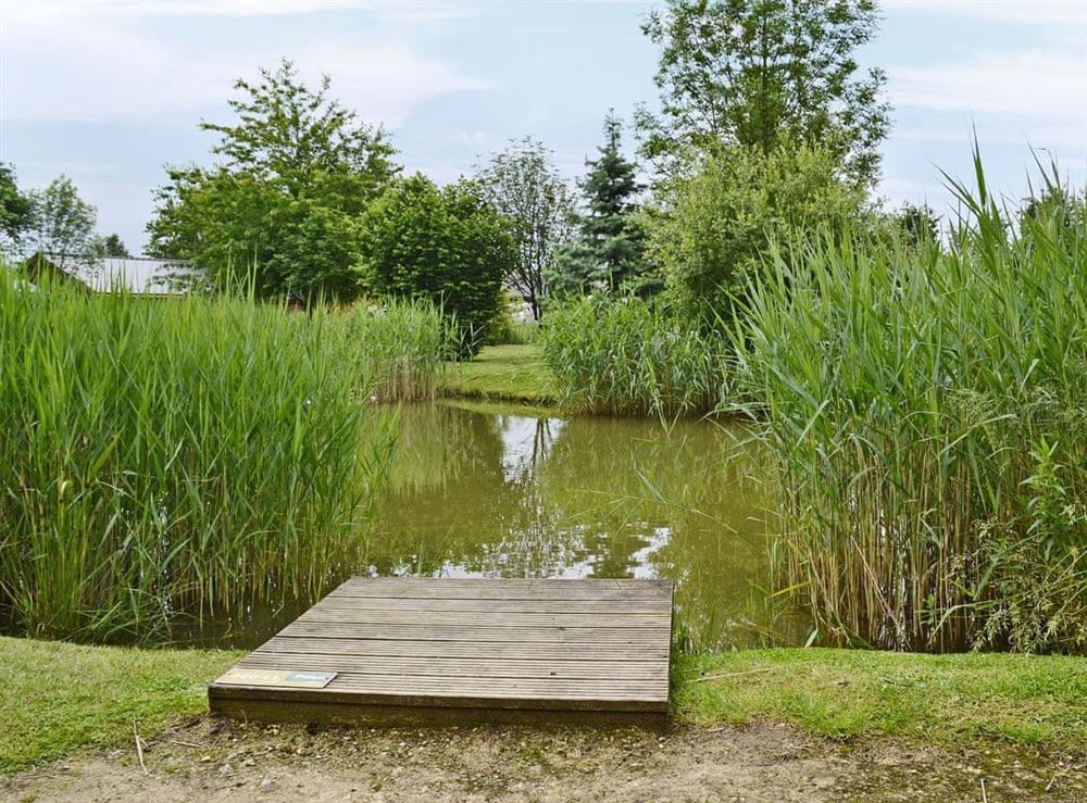 Set alongside a fishing lake at Sunnyside Lodge in Thorpe on the Hill, near Lincoln, Lincolnshire
