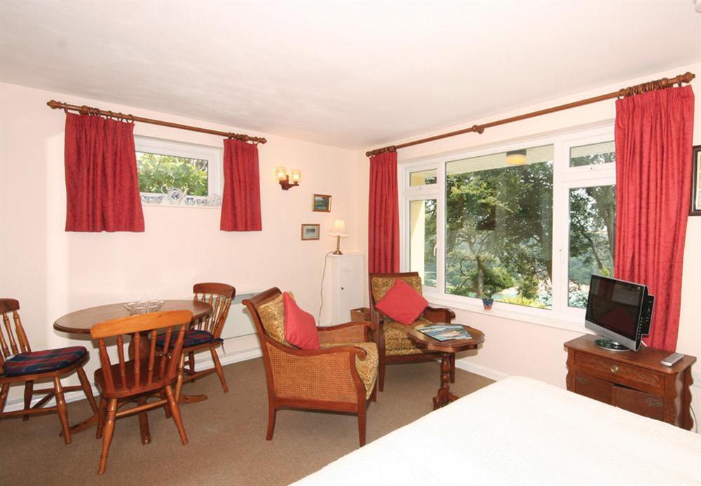 Studio accommodation with bed, dining and sitting areas