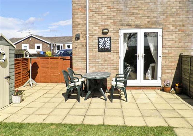 Garden and patio with furniture at Sunset Cottage, Beadnell, Northumberland