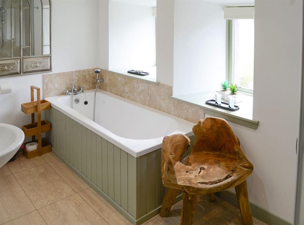 Bathroom with bath and separate shower cubicle at Sunset Cottage in Portmahomack, near Tain, Ross-Shire