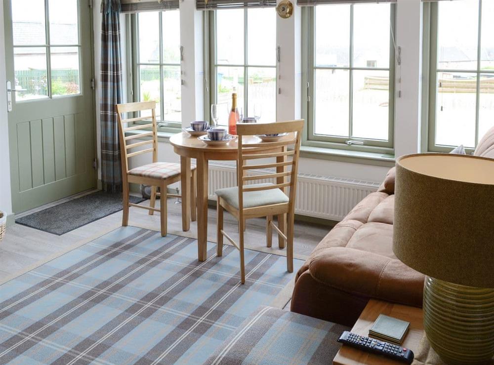 Convenient dining area within living room at Sunset Cottage in Portmahomack, near Tain, Ross-Shire