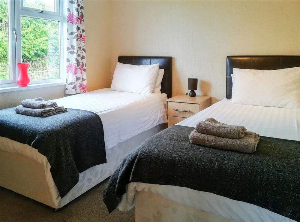 Delightful bedroom with twin single beds at Sunset Lodge in St Ervan, near Padstow, Cornwall, England