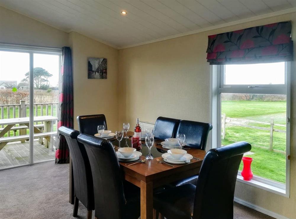 Lovely dining area with dual aspect views at Sunset Lodge in St Ervan, near Padstow, Cornwall, England