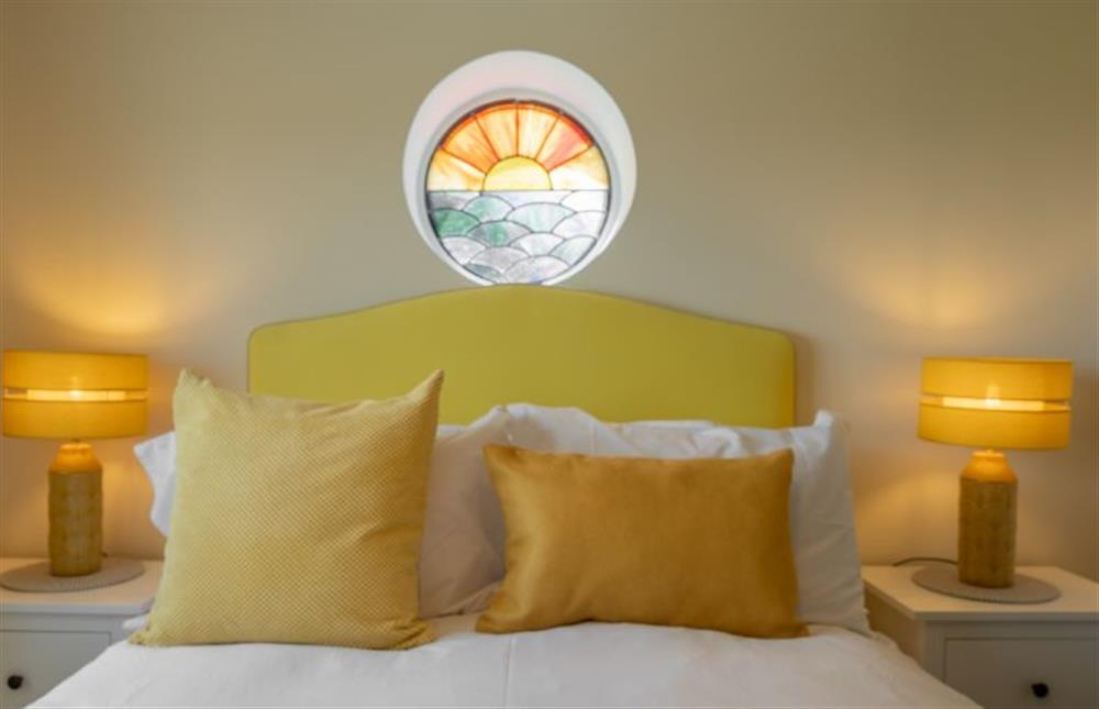 Ground floor:  Bedroom three with a porthole window featuring a sunset at Sunset, Overstrand near Cromer