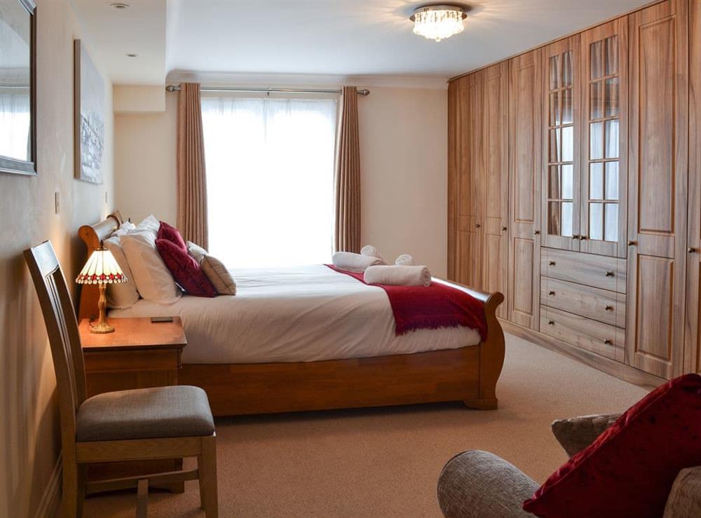 Spacious double bedroom with French doors leading to Juliet balcony (photo 2) at Sunsets@Spinnakers in Newquay, Cornwall