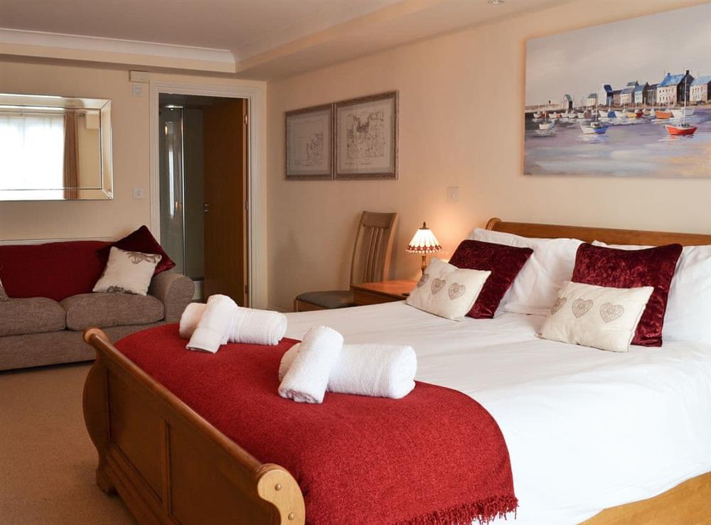 Spacious double bedroom with French doors leading to Juliet balcony at Sunsets@Spinnakers in Newquay, Cornwall