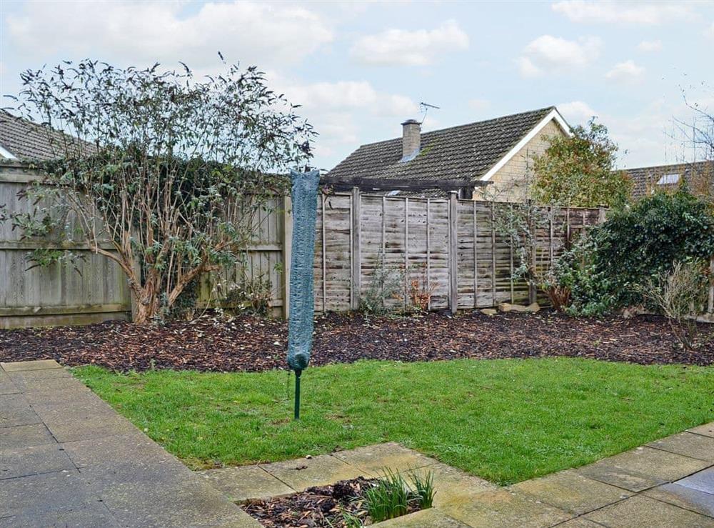 Lovely enclosed lawned garden at Sunshine Cottage in Fairford, near Cirencester, Gloucestershire