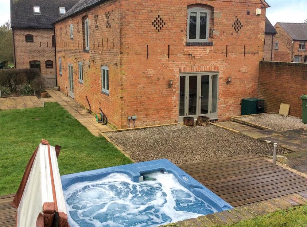South-facing patio with hot tub at Sunshine Cottage in Kirk Langley, Ashbourne, Derbyshire., Great Britain