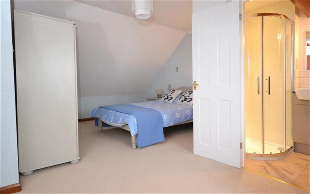 The attic bedroom with double bed, sea views and en suite shower room at Surf View in Hope Cove