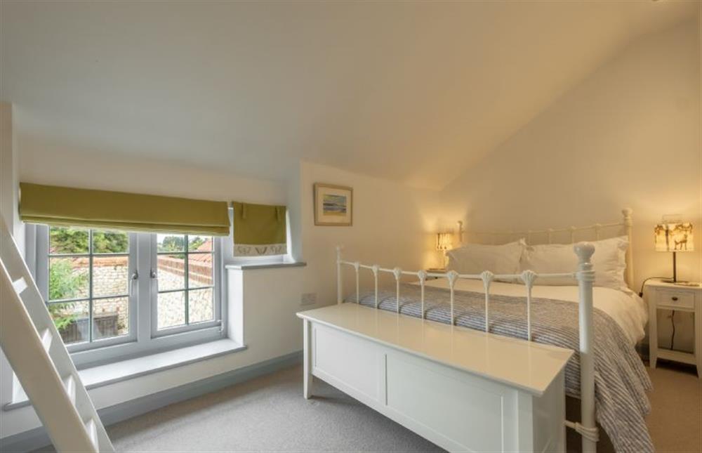 Bedroom two, double bed with additional raised single bed at Sutton Cottage, Thornham near Hunstanton