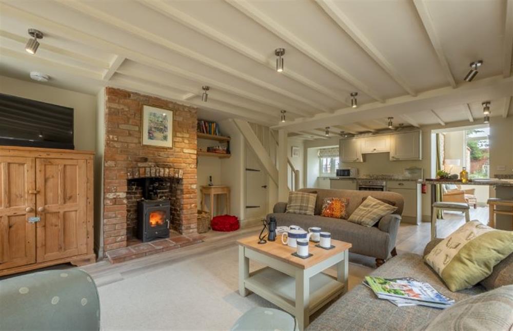 Cosy sitting room with wood burning stove (photo 2) at Sutton Cottage, Thornham near Hunstanton