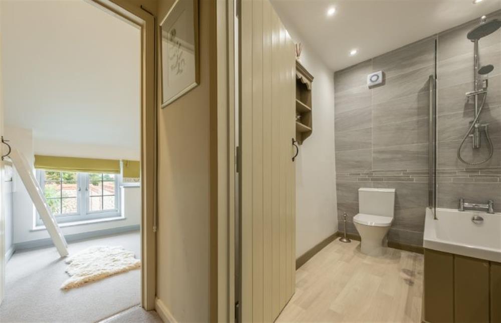 Family bathroom with bath and shower over at Sutton Cottage, Thornham near Hunstanton