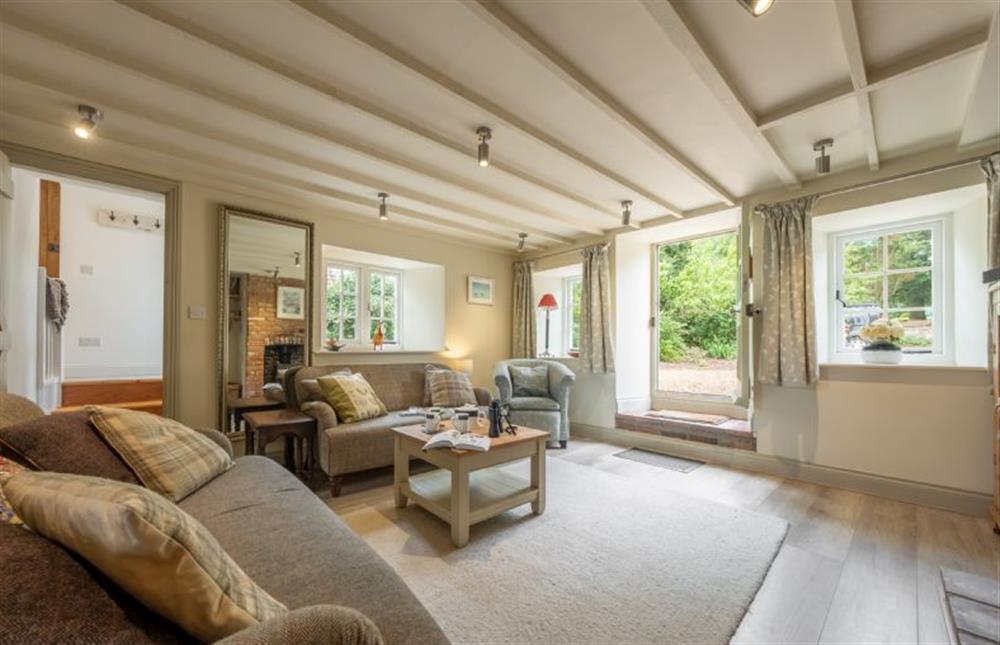 The spacious sitting room is nice and light at Sutton Cottage, Thornham near Hunstanton
