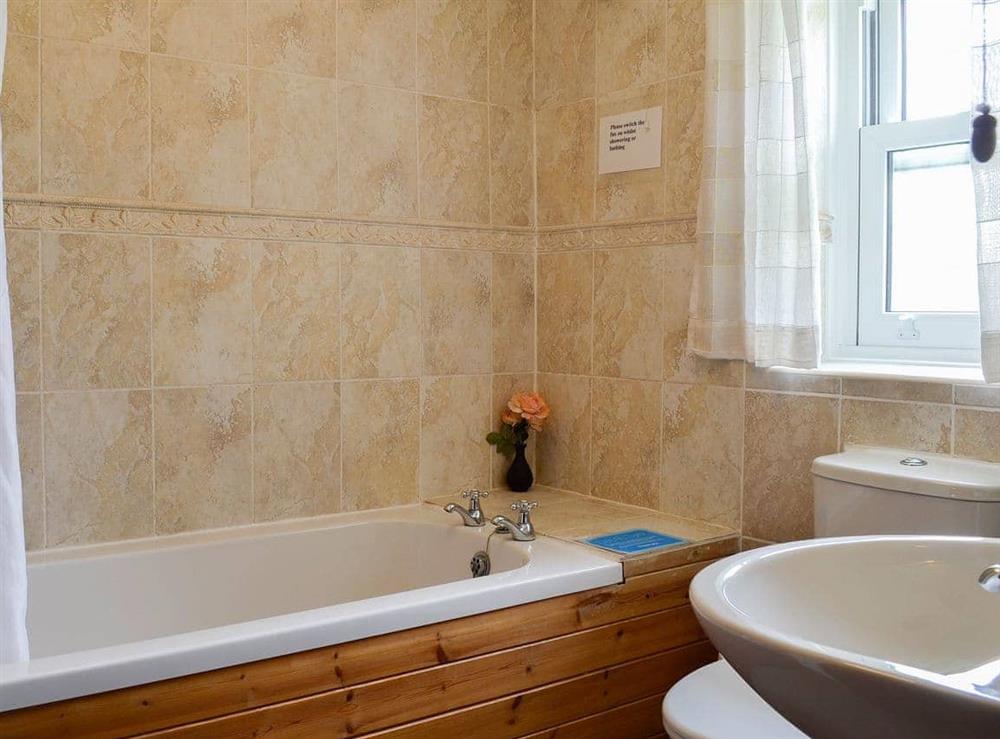 Bathroom with shower over the bath at Swaledale Cottage in Caldbeck, near Keswick, Cumbria