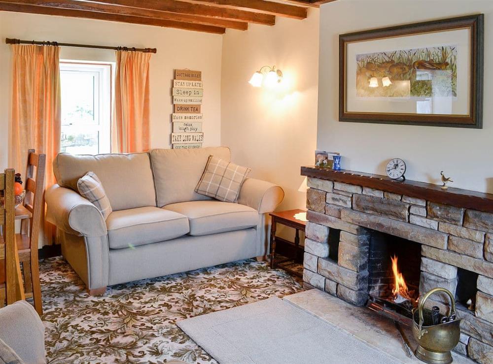Beamed open plan living space at Swaledale Cottage in Caldbeck, near Keswick, Cumbria