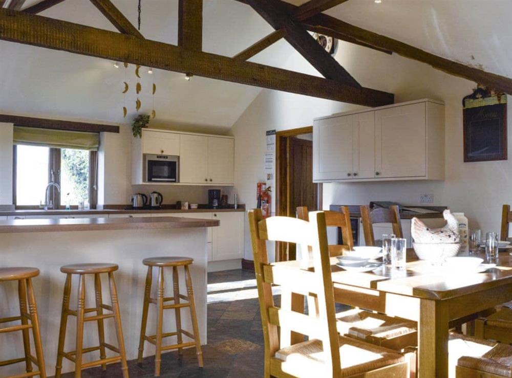 Large kitchen/diner with exposed wooden beams at Swallow Barn in Warkworth, Banbury, Oxon., Oxfordshire
