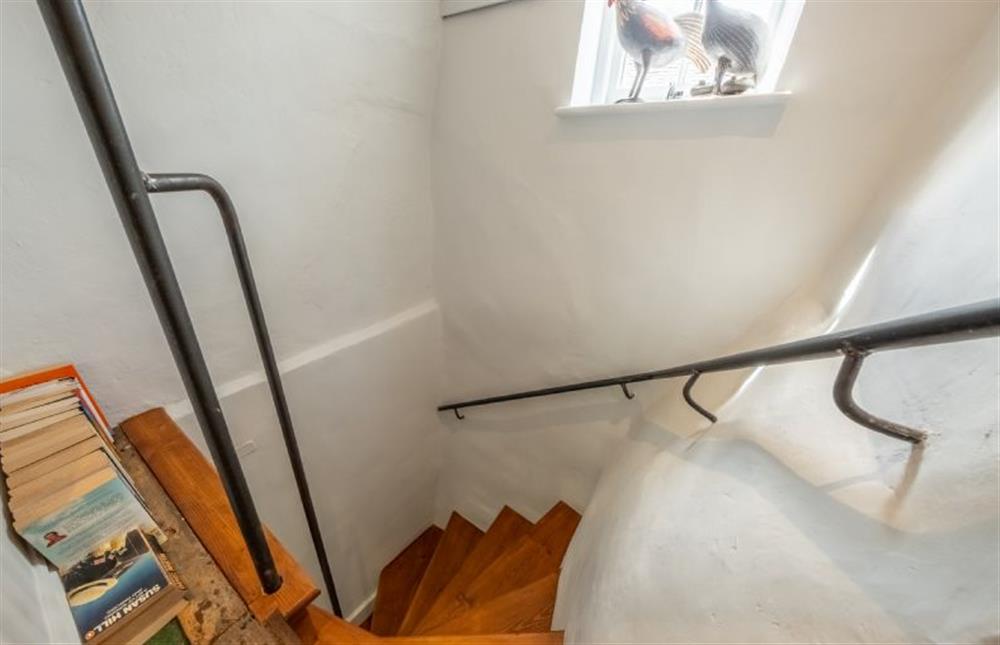 Handrails guide you up and down the winder stairs at Swallow Cottage, Binham near Fakenham