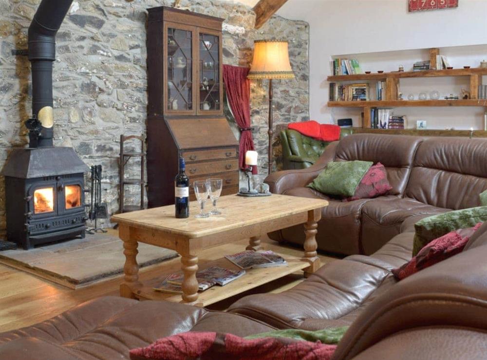 Warm and cosy living area with wood burner at Swallow Lodge in Mathry, near St Davids, Dyfed