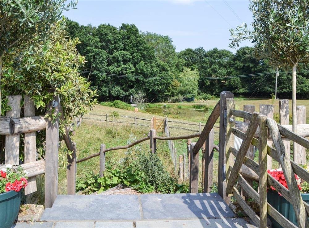 Gate to steps down to wild flower meadow at Swallow’s Barn in Ashburnham, Battle, E. Sussex., East Sussex