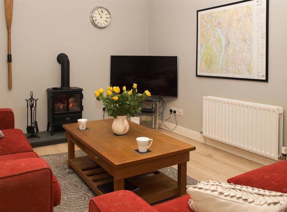 Welcoming living area with wood burner at Swallows Nest in Windermere, Cumbria