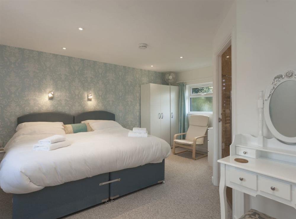 Peaceful bedroom with super-king bed, Freeview TV and en-suite at Swallows Nest in Wool, near Wareham, Dorset