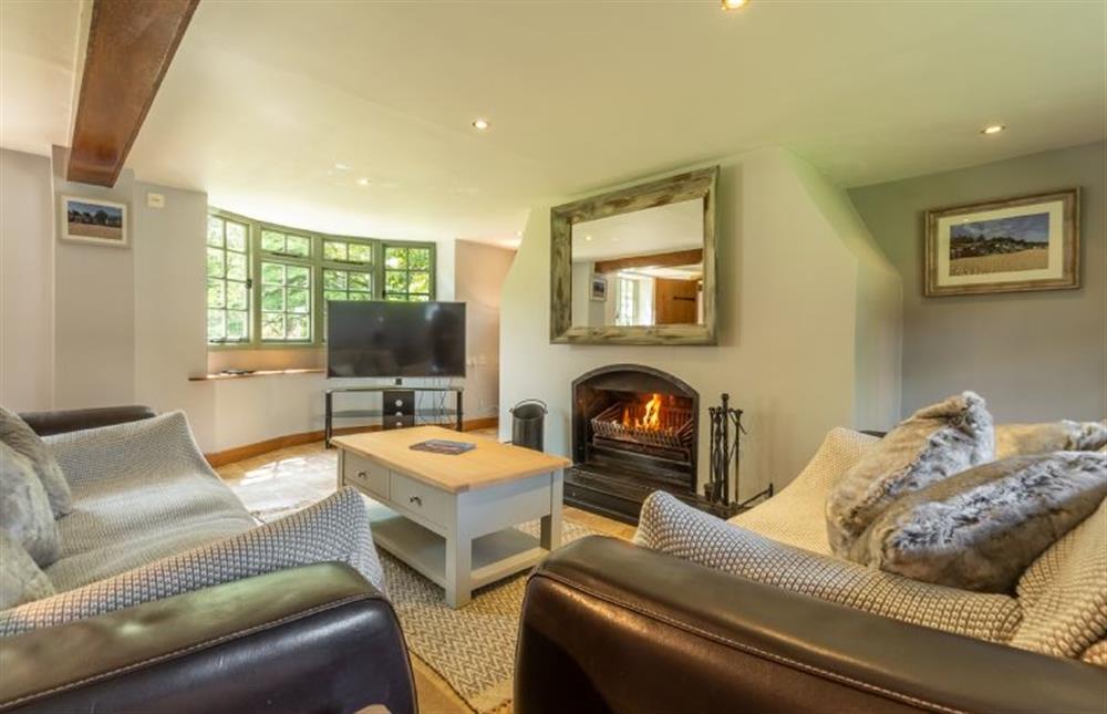 Swan Cottage: Sitting room featuring a log burner and comfy seating  (photo 2) at Swan Cottage, South Creake near Fakenham