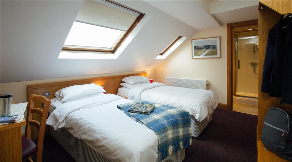 A first floor bedroom at Swan Group House in Pembroke, Pembrokeshire
