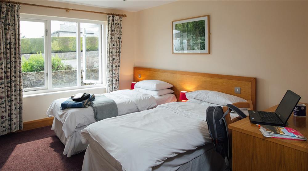 A ground floor bedroom at Swan Group House in Pembroke, Pembrokeshire