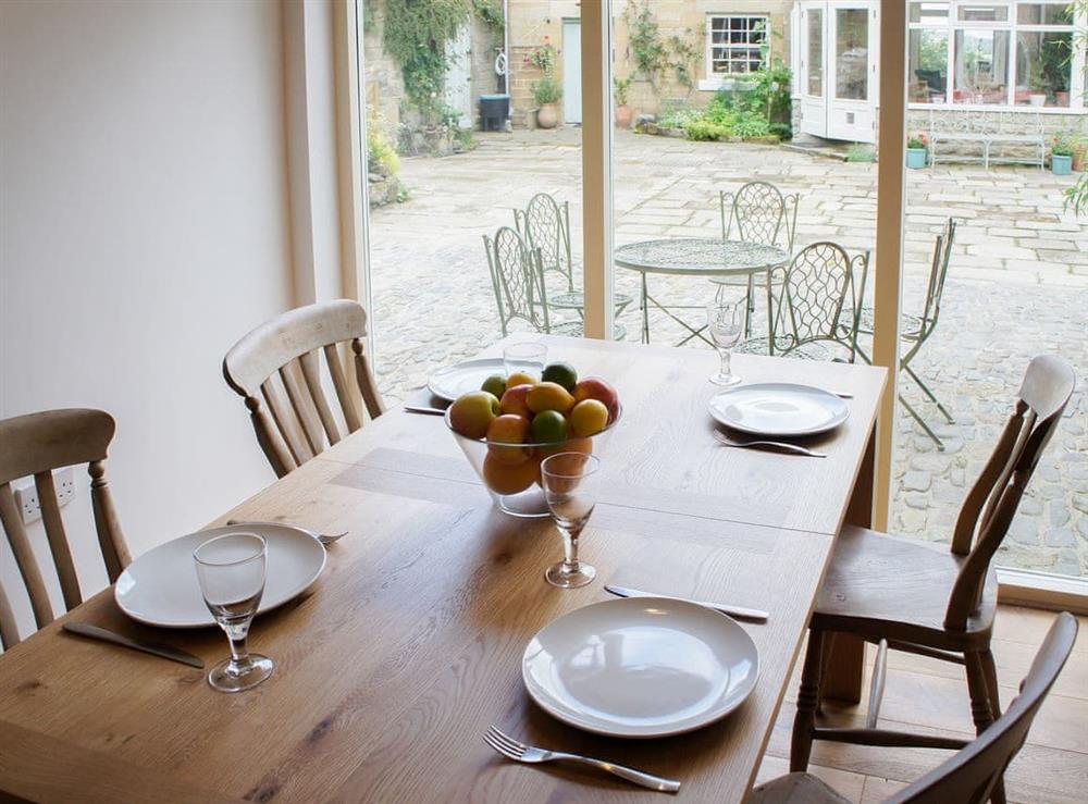 Dining area with view out over the courtyard at Swansfield Stables in Alnwick, Northumberland