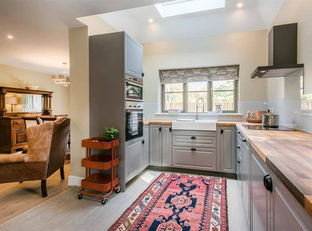 Well-equipped kitchen within the open plan living space at Cowslip Cottage, 