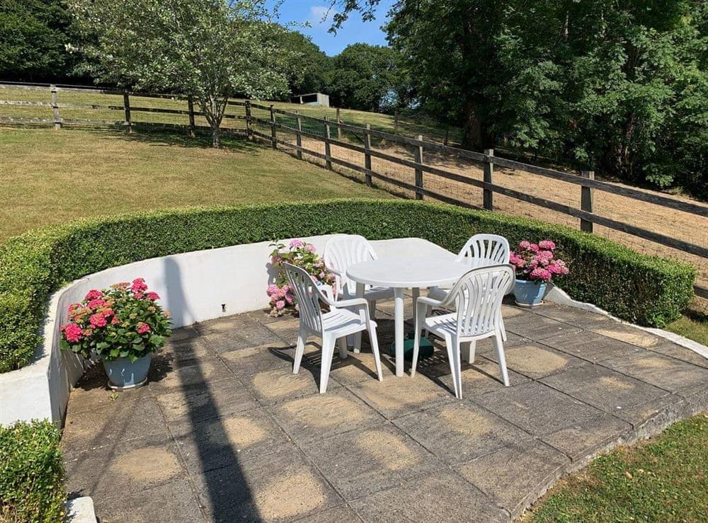 Paved patio with table and chairs at Sweet’s Close in Polgooth, St Austell, Cornwall., Great Britain