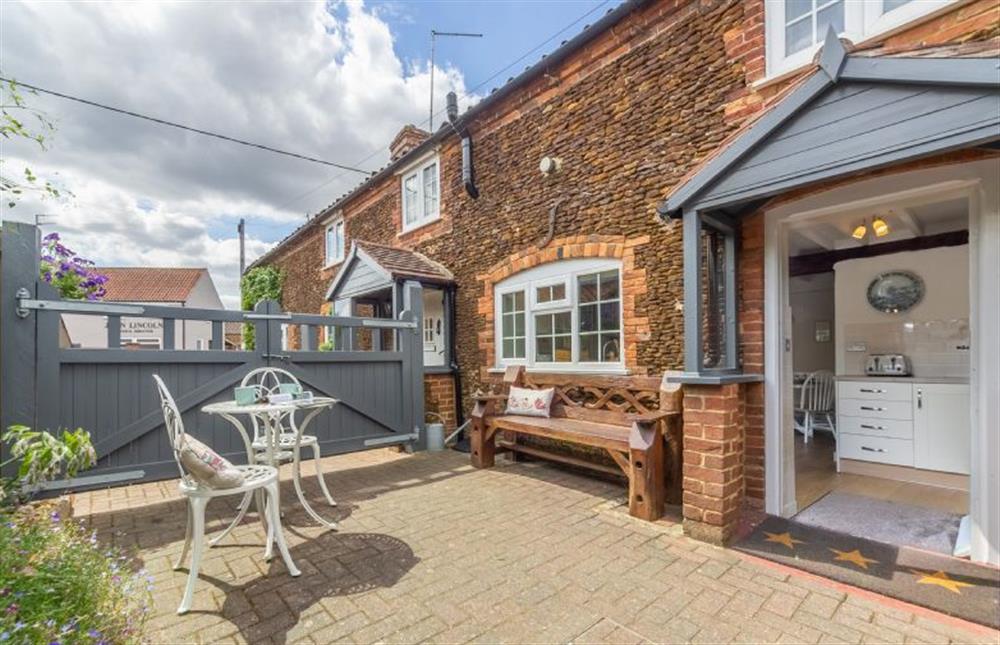 Enclosed paved courtyard:  With table with seating for two at Swift Cottage, Dersingham near Kings Lynn