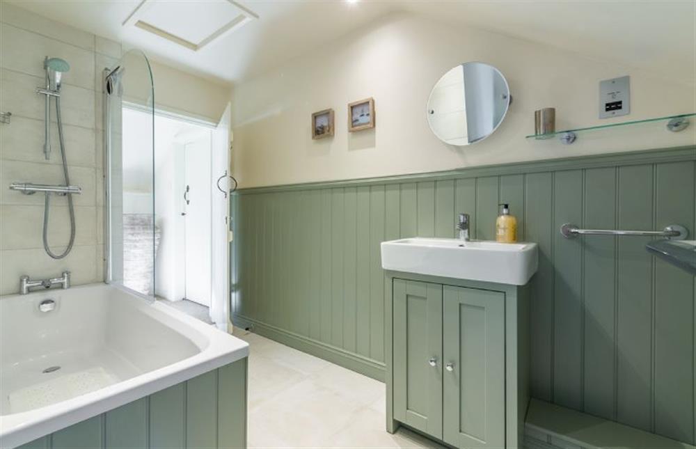 First floor:  Bathroom with bath with shower over at Swift Cottage, Dersingham near Kings Lynn