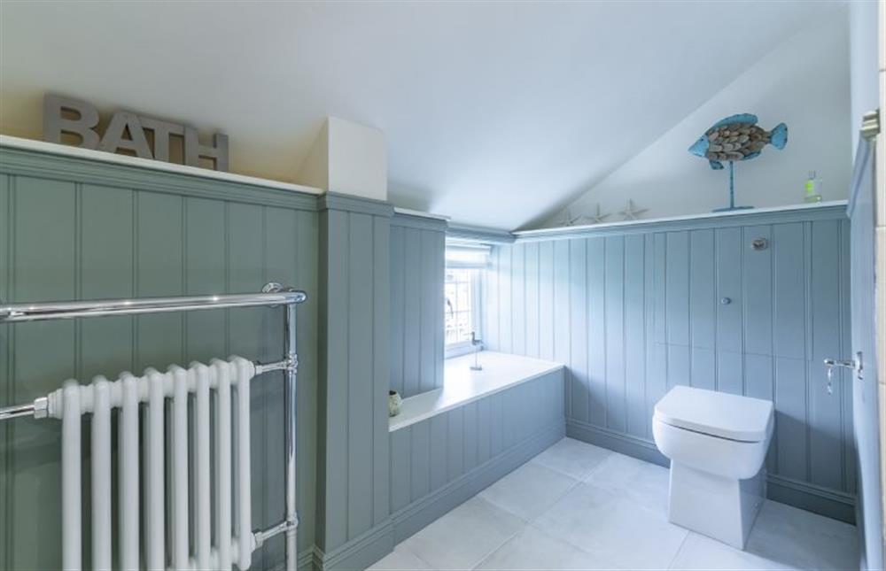 First floor:  Bathroom with tongue and groove painted paneling at Swift Cottage, Dersingham near Kings Lynn