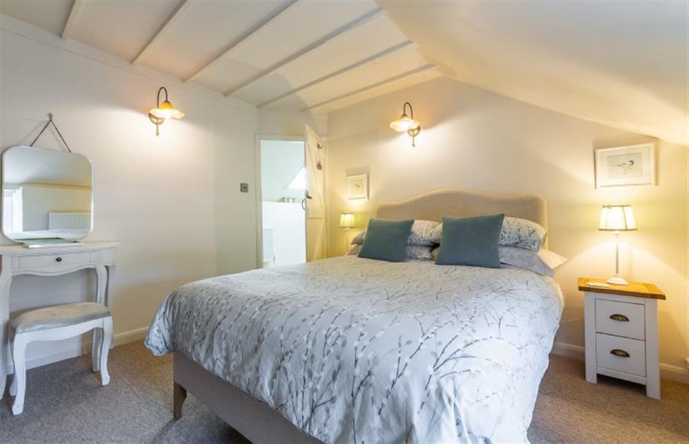 First floor:  Double bedroom with sloping beamed ceiling  at Swift Cottage, Dersingham near Kings Lynn
